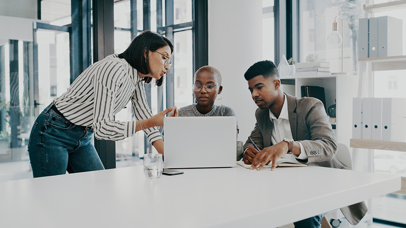 Three colleagues working in a conference room