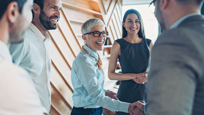 retiring ceo shaking hands with team