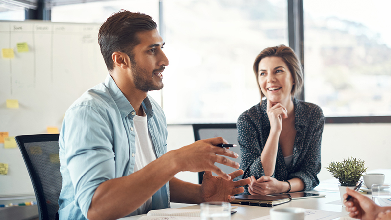 Two people talking in a conference room