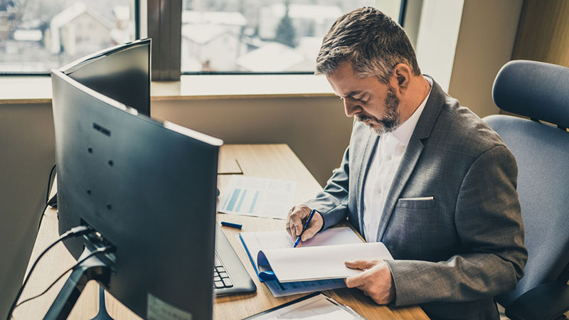 Man reading a report at his desk