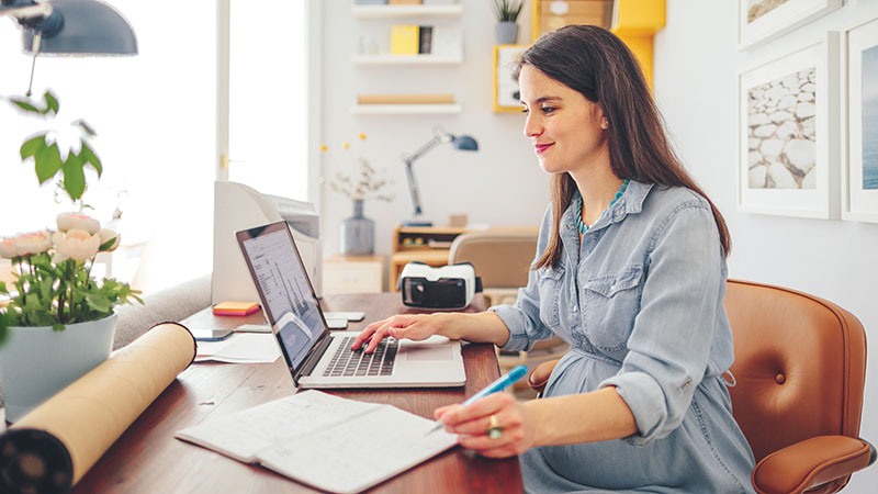 Pregnant woman working in her at-home office