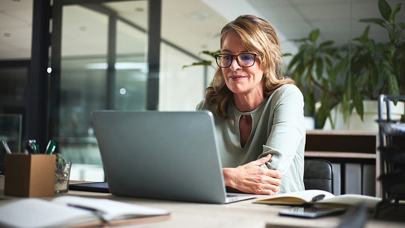 A woman looking at a laptop