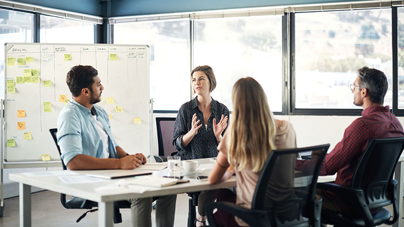 Four colleagues having a meeting in a conference room